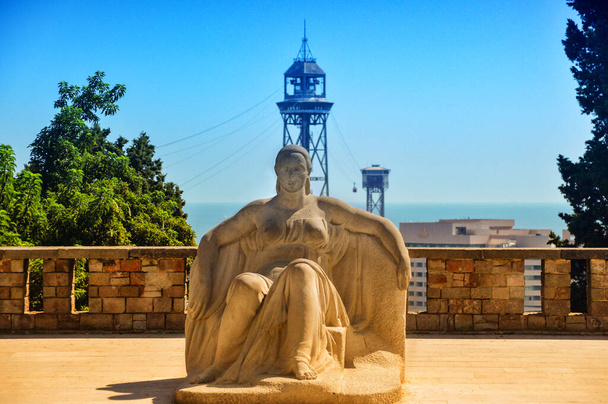 BARCELONA, SPAIN, August 21 2017: A female sculpture on the hill Montjuic with The Port Fell Aerial Tramway at background in Barcelona, Spain. - Valokuva, kuva