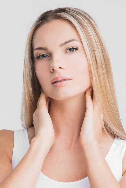 Beautiful blonde woman with long straight hair on a white background beauty skincare concept - Φωτογραφία, εικόνα