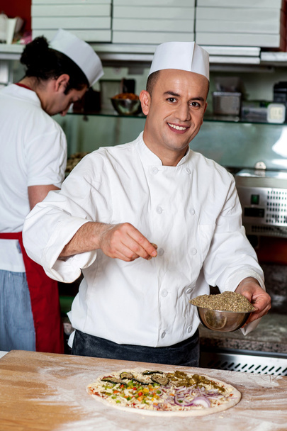 Male chefs actively working in kitchen - Foto, Imagen