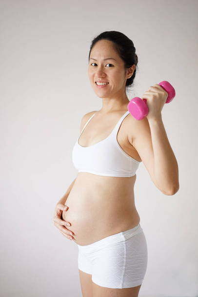 Confident healthy Asian Chinese pregnant mother keeping healthy - Fotografie, Obrázek
