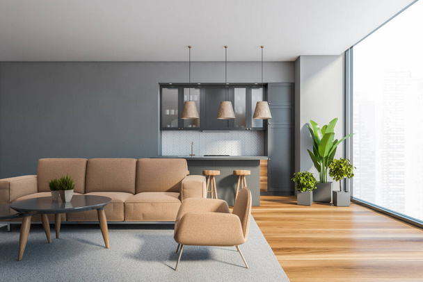 Front view of stylish living room with gray walls, beige sofa and armchairs standing near round coffee tables and kitchen with gray cupboards in background. Blurry cityscape. 3d rendering - Fotoğraf, Görsel
