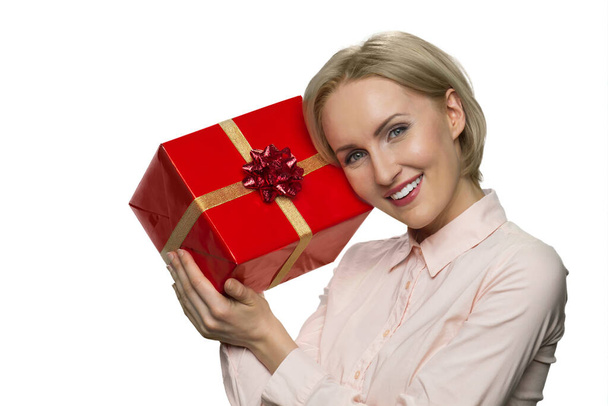 Portrait of smiling joyful woman with celebratory gift box. - 写真・画像