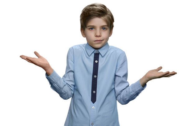 Confused boy giving I dont know gesture on white background. - Photo, Image
