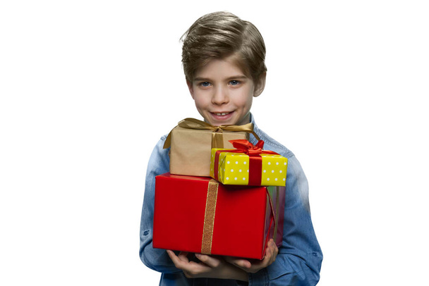 Smiling little boy holding present boxes. - Fotoğraf, Görsel