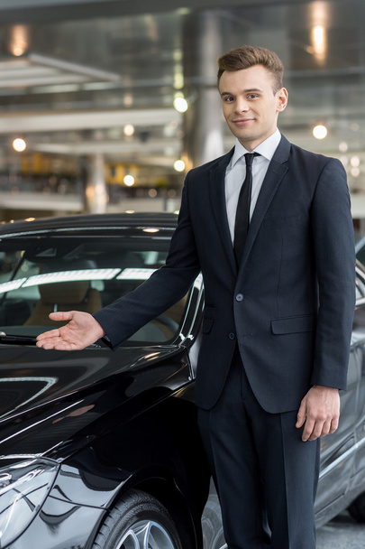 Handsome young car salesman - 写真・画像