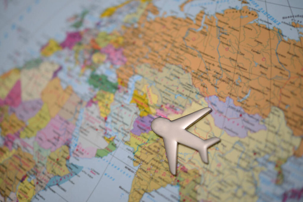 Travel with plane, small toy plain on globe map background, traveling and logistic  concept  - Zdjęcie, obraz