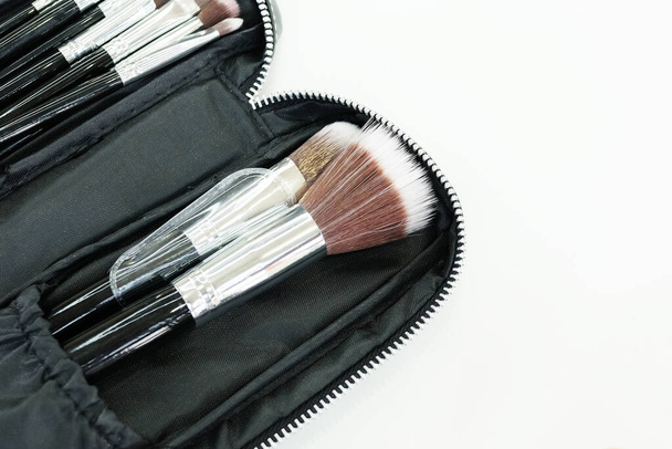 Brush on in black bag cosmetics of make up artist isolated on white background. - Photo, Image