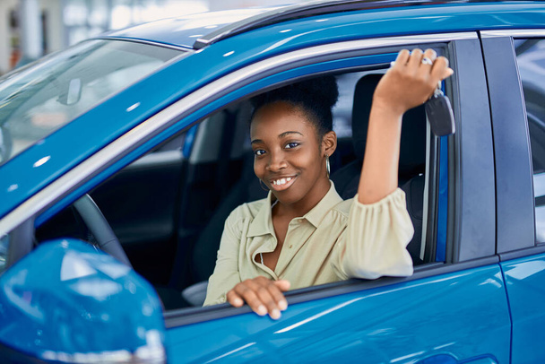 houkutteleva afro nainen nauttia omistaa uuden auton - Valokuva, kuva