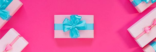 Banner from set of beautiful gift boxes with blue bows on pink background. Holiday sale. Copy space for your text. Flat lay, top view, copy space concept - Fotó, kép