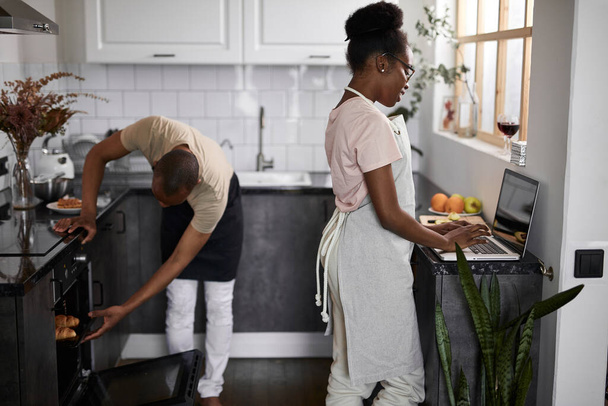 friendly african couple is cooking together in the kitchen - Foto, imagen
