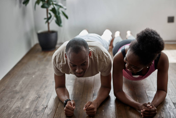 african man and woman do workout at home - Fotó, kép