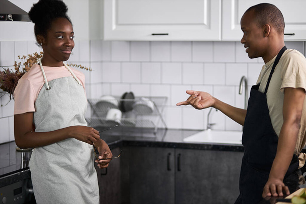 beautiful african couple have conversation in the kitchen - Fotó, kép