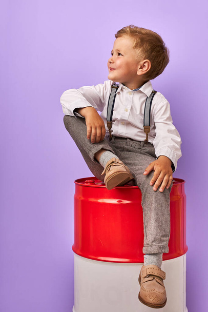 future businessman, child boy sitting on oil barrel - Fotografie, Obrázek