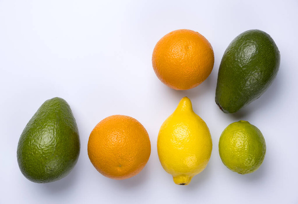 Close up of citrus fruits orange, lemon, avocado and lime isolated on white background. - Φωτογραφία, εικόνα