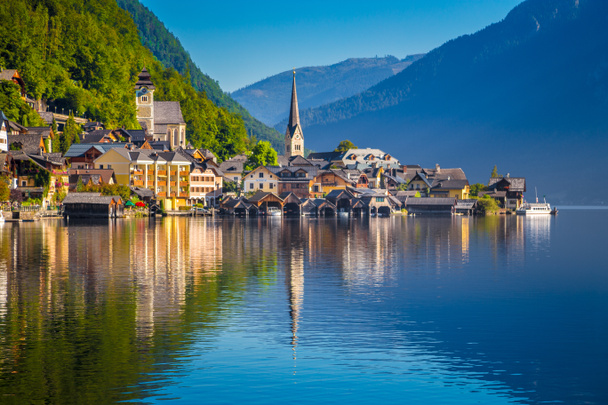 Classic postcard view of famous Hallstatt lakeside town in the Alps in scenic golden morning light at sunrise on a beautiful sunny day in summer, Salzkammergut region, Austria - Photo, Image
