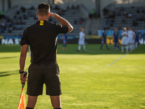 Touchline referee looking against the light during the soccer match. - Photo, Image