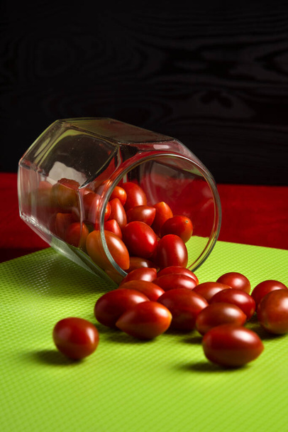 Tomates cerises dans un bocal en verre sur la table - Photo, image