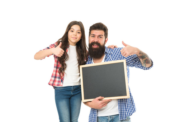 Family news. Awesome news. Small girl with dad on white background. Happy childhood. Advertising or promotion. Father and daughter hold chalkboard copy space. Fathers day. International childrens day - Foto, Imagen