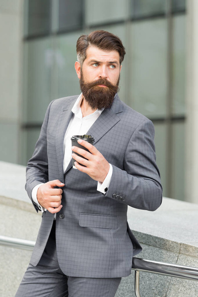 bearded businessman drink coffee to go. formal man in office suit drinking coffee from paper cup. good morning coffee. take away drink. confident businessman need inspiration - Фото, изображение