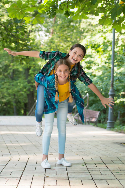Having fun together. childhood happiness. happy childrens day. spend time and have fun together. best school friends. concept of friendship. small happy girls wear checkered shirt. kid casual fashion - Fotoğraf, Görsel