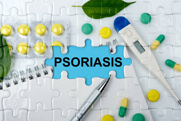 Double exposure. Puzzles with the image of tablets, a notebook, a thermometer and a pen with the inscription -PSORIASIS. The concept of medicine. - Photo, Image