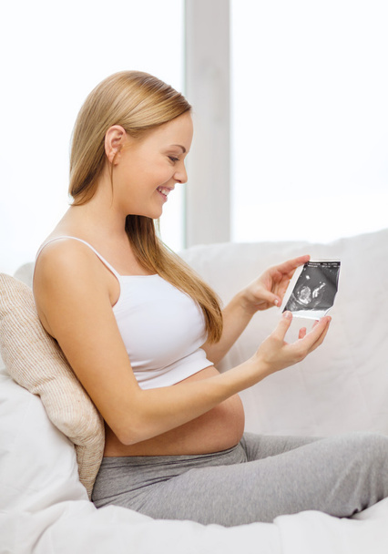 Happy pregnant woman with ultrasound picture - Fotó, kép