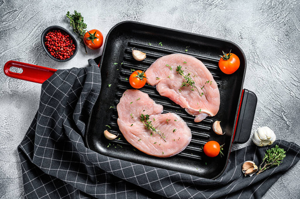 Raw Turkey breast steaks in a pan. organic poultry meat. Gray background. Top view. - Valokuva, kuva