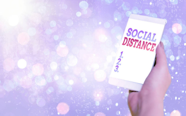 Text sign showing Social Distance. Conceptual photo maintaining a high interval physical distance for public health safety Modern gadgets with white display screen under colorful bokeh background. - Photo, Image