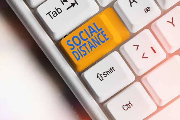 Text sign showing Social Distance. Conceptual photo maintaining a high interval physical distance for public health safety Different colored keyboard key with accessories arranged on empty copy space. - Photo, Image