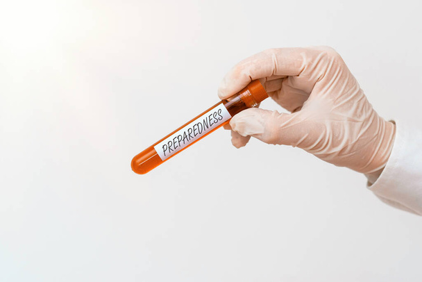 Writing note showing Preparedness. Business photo showcasing quality or state of being prepared in case of unexpected events Extracted blood sample vial ready for medical diagnostic examination . - Photo, Image