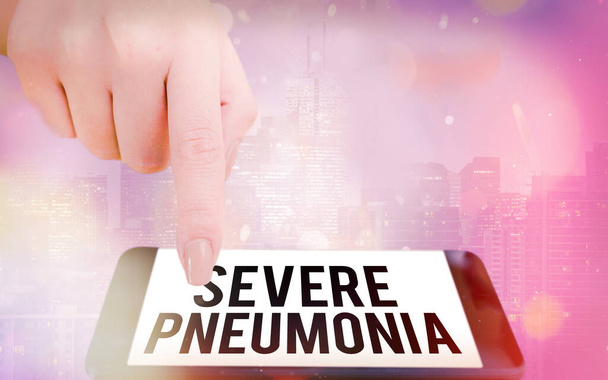 Writing note showing Severe Pneumonia. Business photo showcasing acute disease that is marked by inflammation of lung tissue Modern gadgets white screen under colorful bokeh background. - Photo, Image