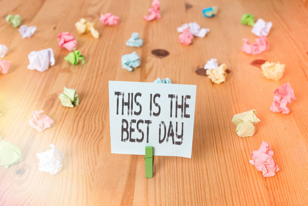 Handwriting text This Is The Best Day. Concept meaning used to refer to something very good happened today Colored crumpled papers empty reminder wooden floor background clothespin. - Photo, Image