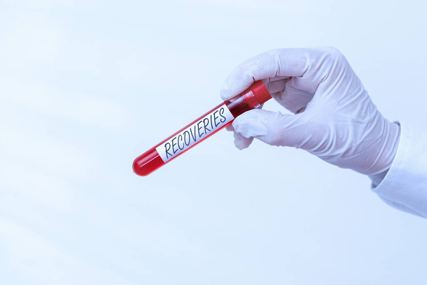 Writing note showing Recoveries. Business photo showcasing process of regaining possession or control of something lost Extracted blood sample vial ready for medical diagnostic examination . - Photo, Image