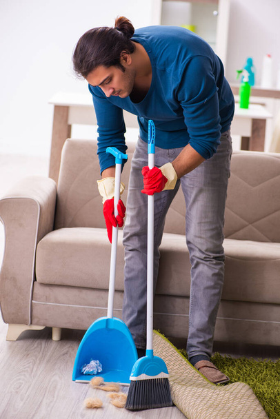 Young man husband doing housework at home - Photo, Image