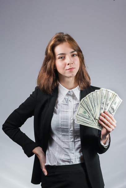 Businesswoman with wad of money in her hands - Foto, Imagen