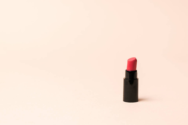 A small bottle of lipstick on a pastel background. - Φωτογραφία, εικόνα