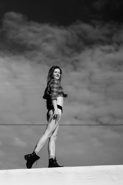 young woman in good physical shape against the sky, dam - Foto, imagen