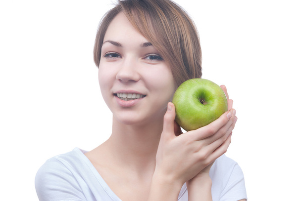 Pretty young girl with green apple - Foto, afbeelding