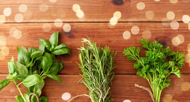 greens, spices or medicinal herbs on wooden boards - Fotografie, Obrázek