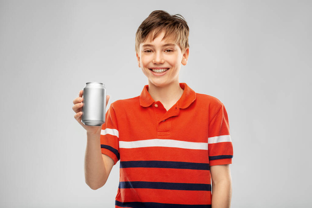 happy smiling boy holding soda drink in tin can - Foto, immagini