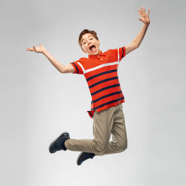 happy smiling young boy jumping in air - Fotoğraf, Görsel