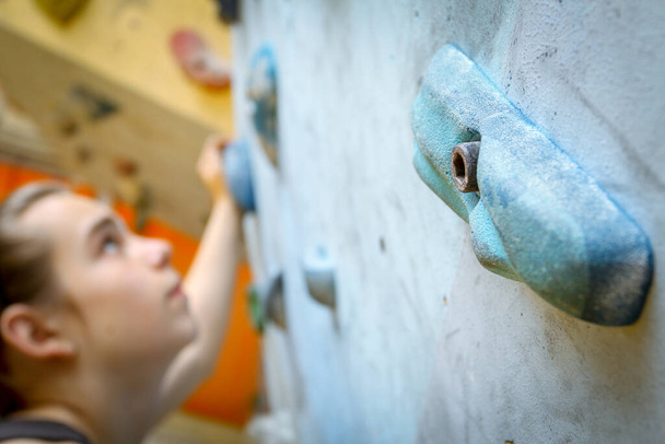Teenage Boy Training Climbing On Indoor Climbing Wall - Фото, зображення