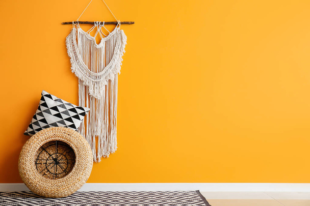 Pillow and wicker pouf near color wall in room - Photo, Image