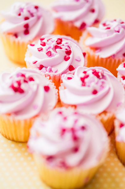 Cupcakes with pink cream and heart sprinkles - Фото, изображение