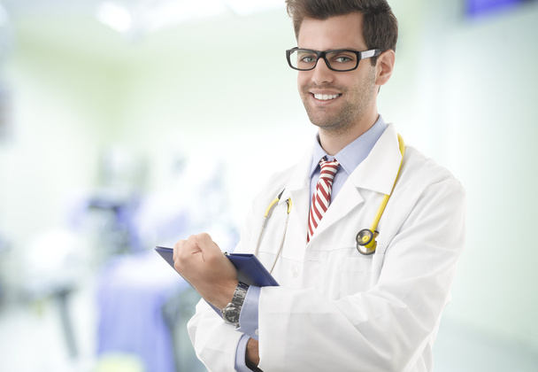 Portrait of happy male doctor with clipboard - Foto, afbeelding