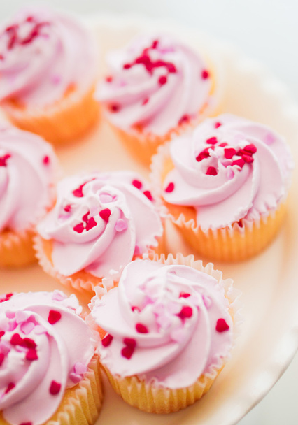 Cupcakes with pink cream and heart sprinkles - Фото, зображення