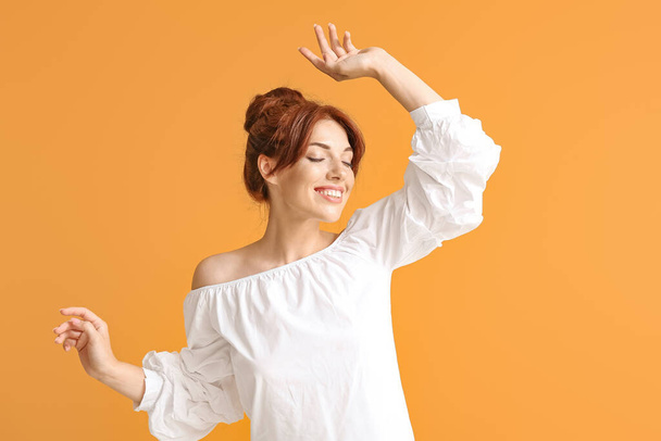 Beautiful redhead woman on color background - Foto, Imagen