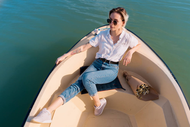 Fashionable woman in sunglasses on the boat - Photo, Image
