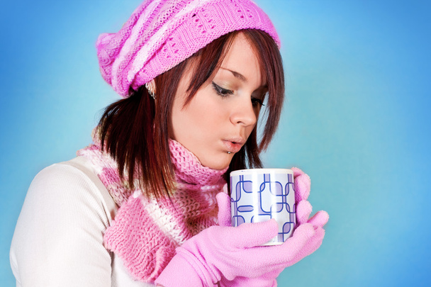 Winter girl blows her tea - Фото, изображение