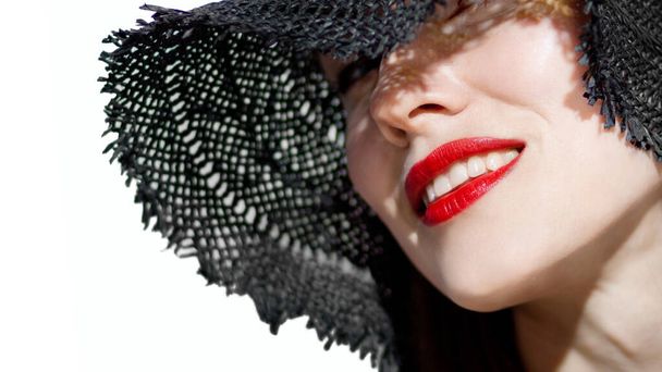 Tender smile. Beautiful woman wearing black hat and red lips, beautiful stranger - Fotoğraf, Görsel
